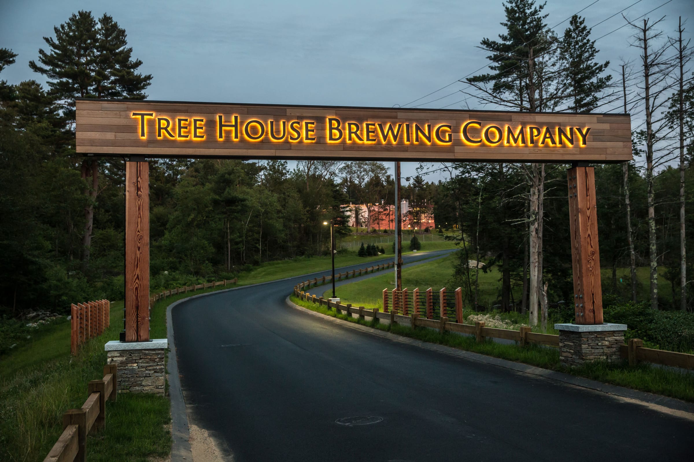Tree House Brewing Company timber gateway sign with lit dimensional letters over a driveway