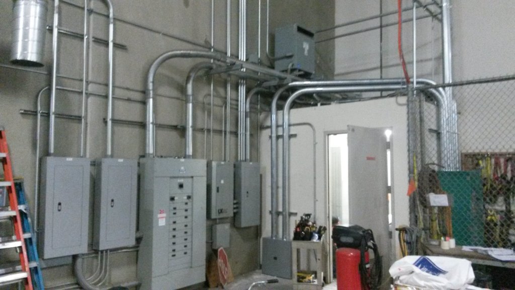 Commercial electrical room with panelboards and EMT conduit runs