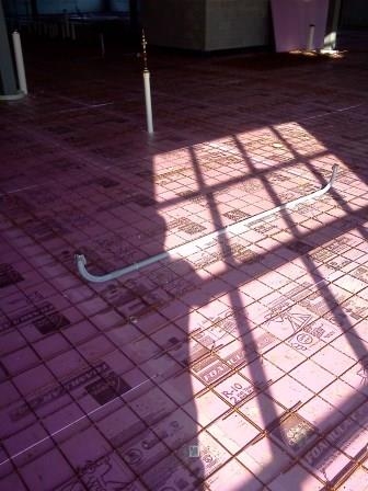 Daylight across a floor of reinforcing mesh with a conduit sweep set in it