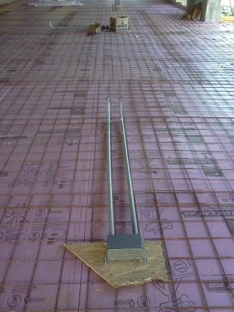 A floor box set on slab reinforcing mesh ahead of the concrete pour