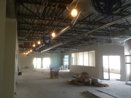 A building shell lit by hanging temporary lights during fit out