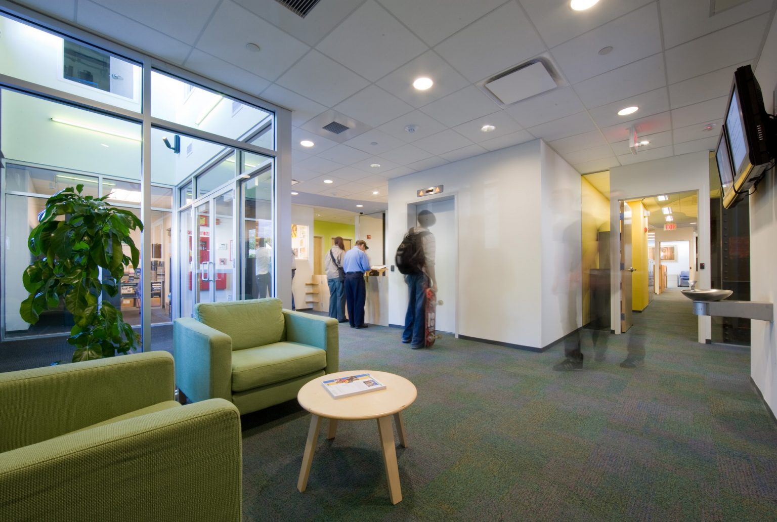 The second-floor lobby, with glass walls opening onto the daylit interior