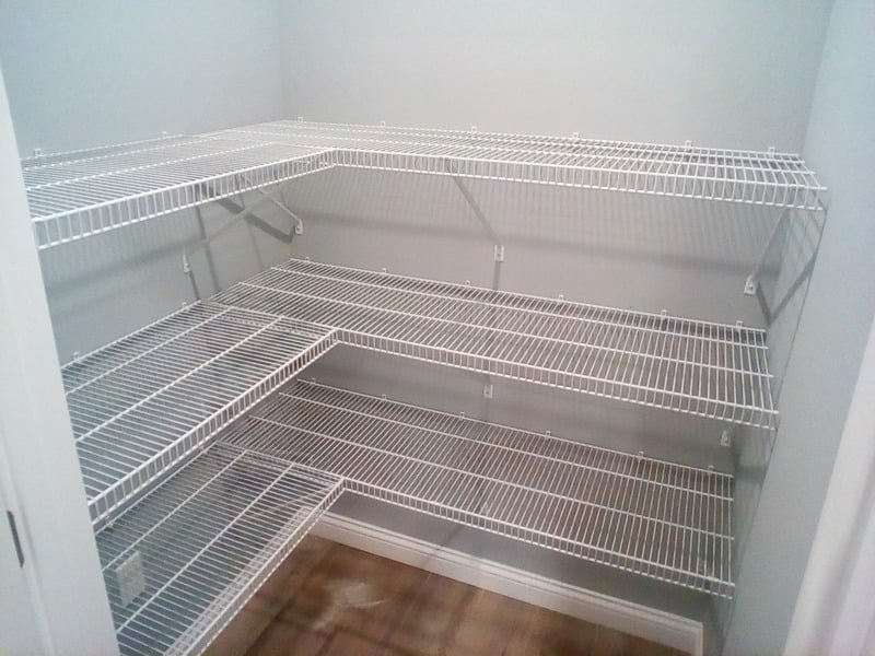 White wire shelving installed on three walls of a closet
