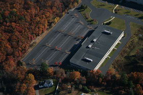 Aerial view of a striped commercial lot in Milford, Massachusetts in autumn