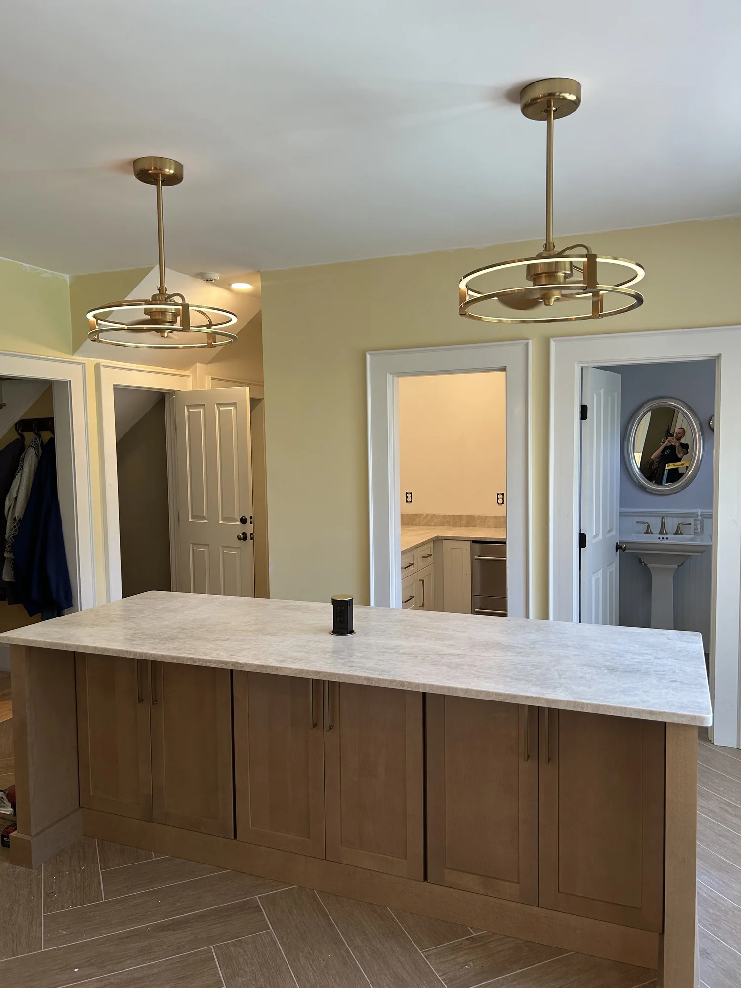 Kitchen island with two circular pendant lights lit