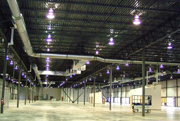 Spiral duct runs across a large warehouse ceiling