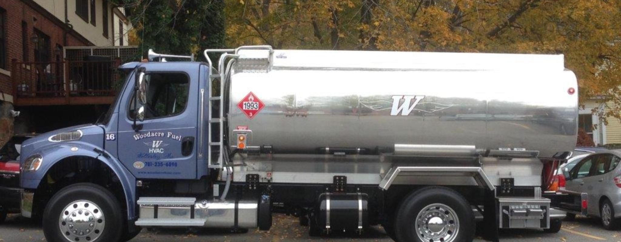 The blue Woodacre Fuel oil delivery truck on a New England street in autumn
