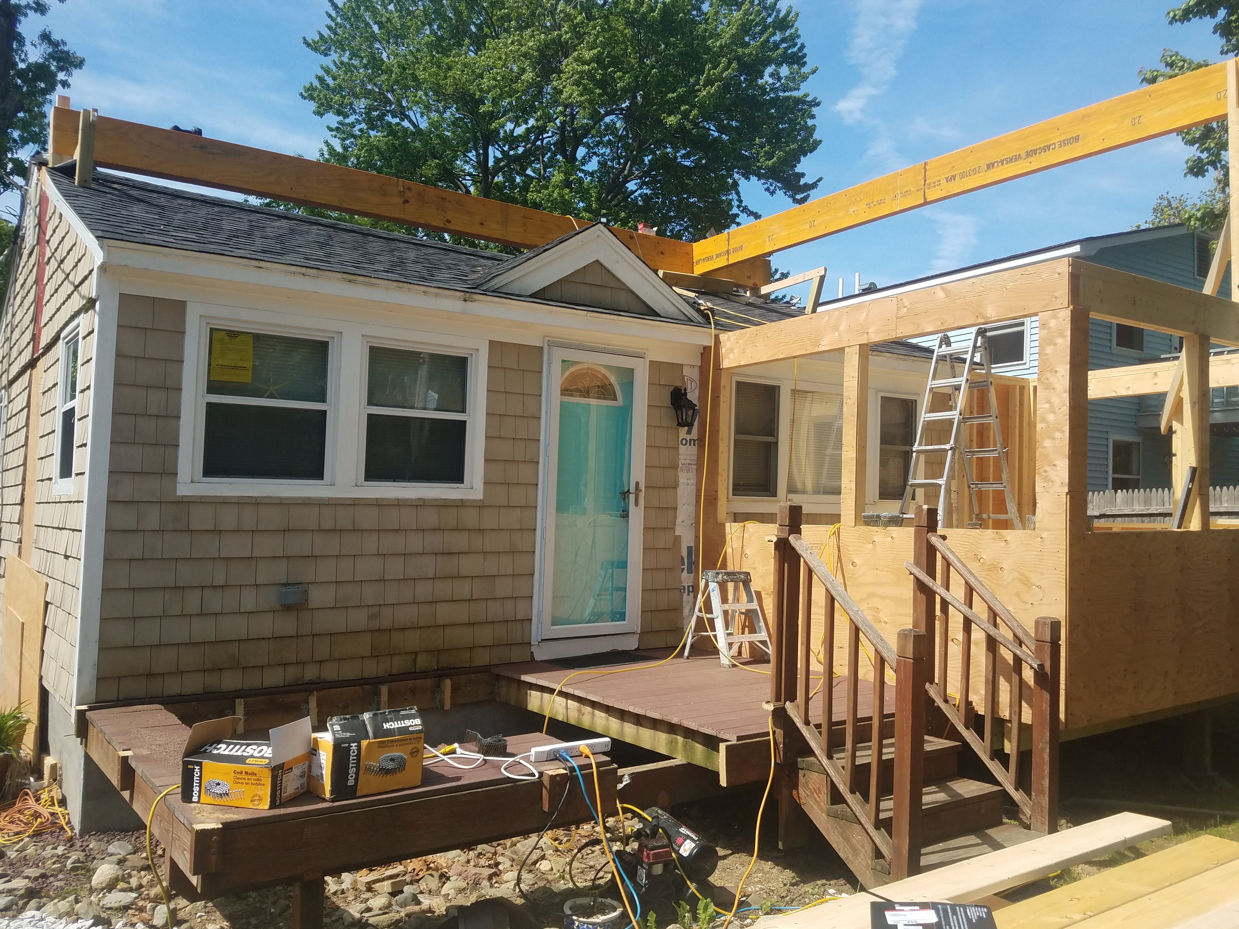New beams and porch framing going up over the old cottage walls