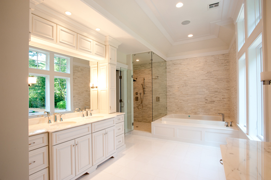 Finished bath with a double vanity, glass shower and a tiled tub deck
