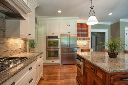 Kitchen with granite counters, a stained wood island and stainless appliances