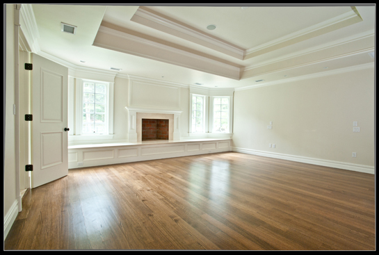 Room with a stepped tray ceiling, a fireplace and a built-in window seat