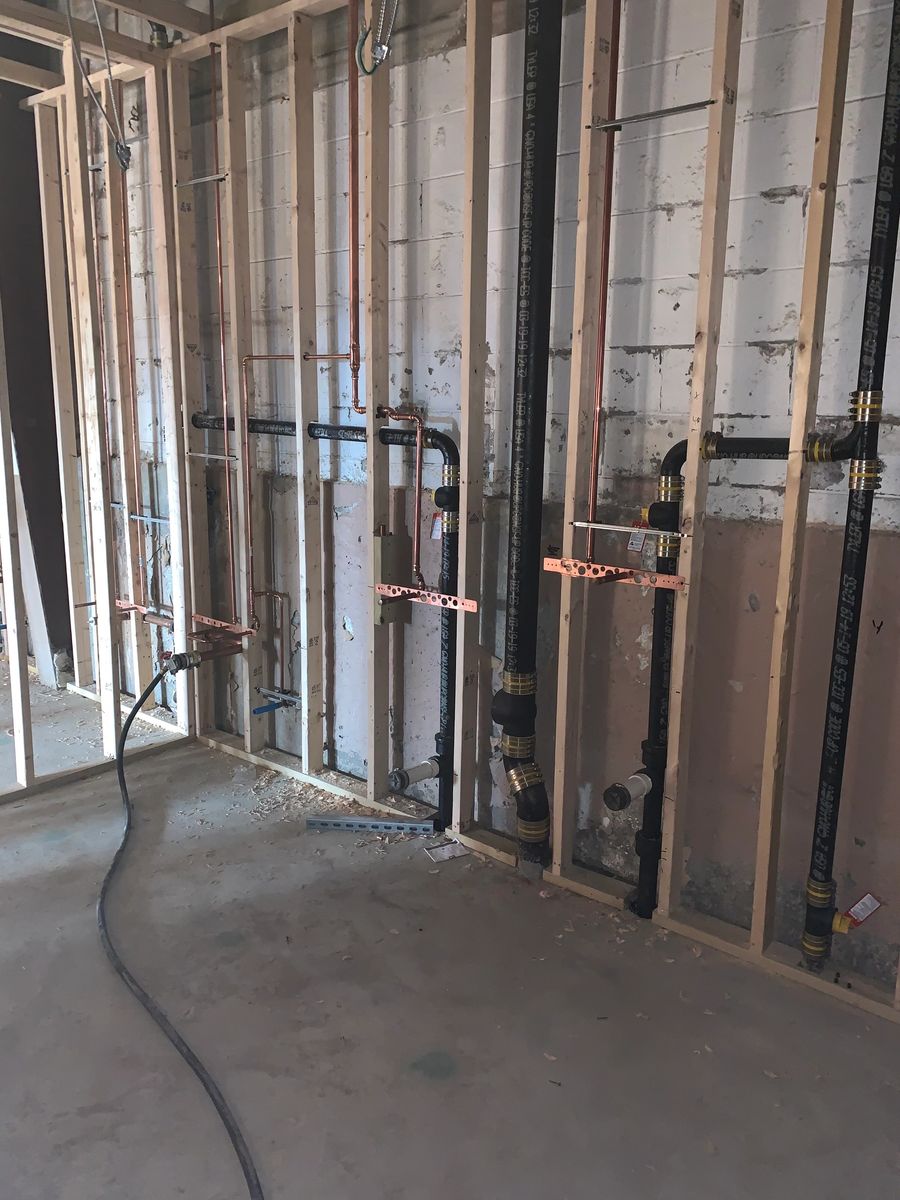Copper and PEX water lines and drain stacks in a framed basement wall