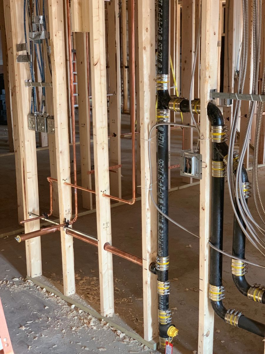 Copper supply lines and drain stacks running through open framing