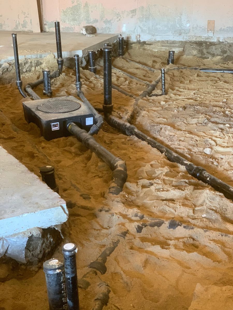 Underslab drain and vent lines laid in an open trench
