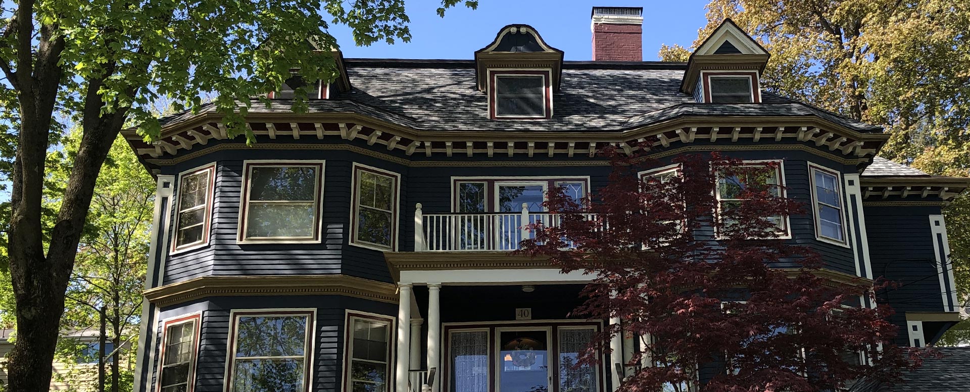 A Victorian house with a turret and a new roof, seen from the street