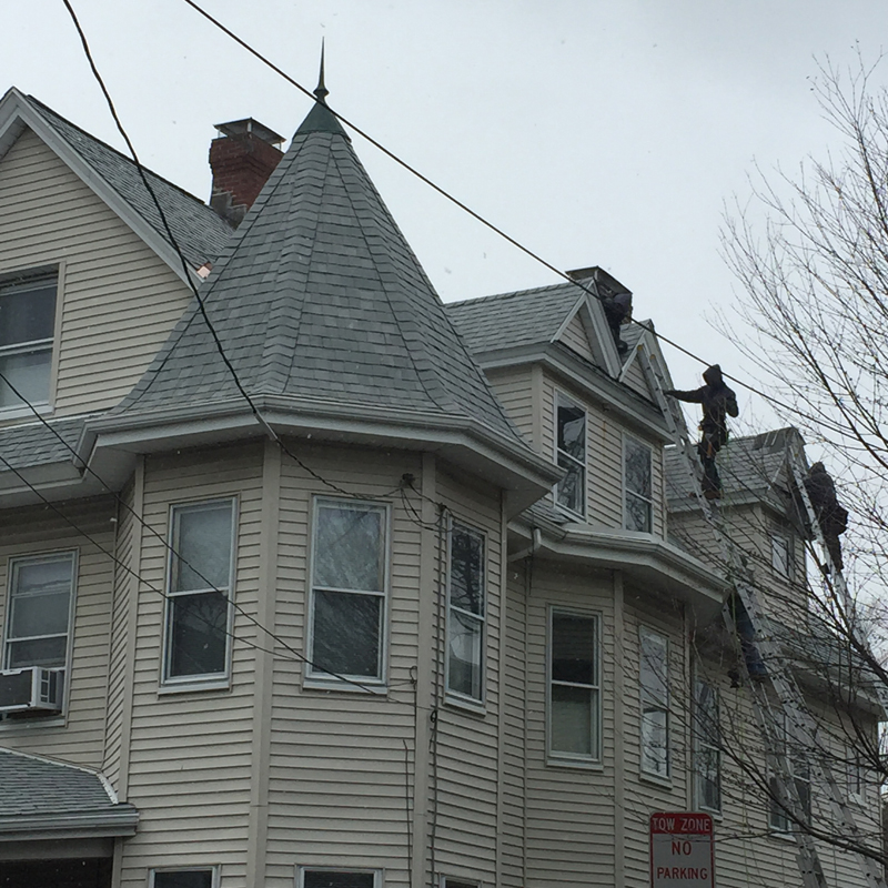 Roofers working high on a Victorian turret roof