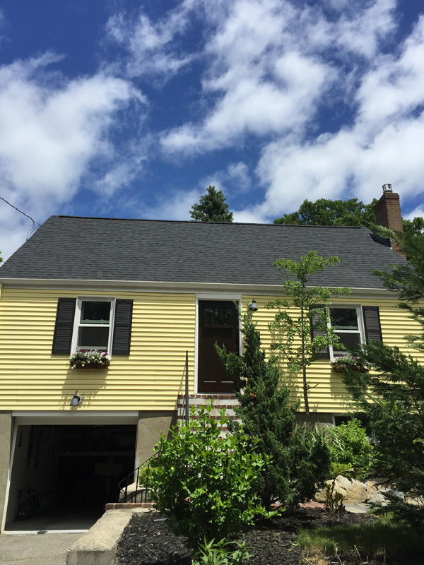 Yellow cape with a new dark roof under a blue sky