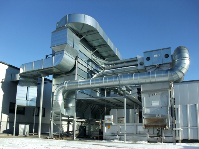 Galvanized sheet metal ductwork on a roof against a clear blue sky