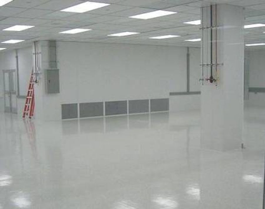 A finished clean interior with a poured seamless floor and a completed ceiling