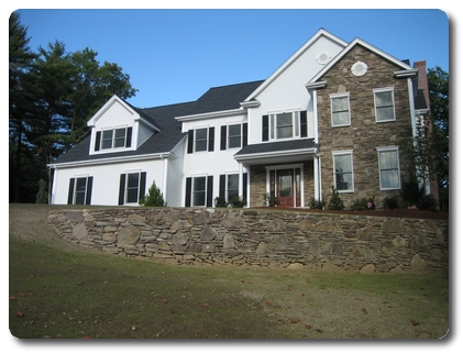 New home built by S. Narducci Construction, with a fieldstone retaining wall along the front lawn