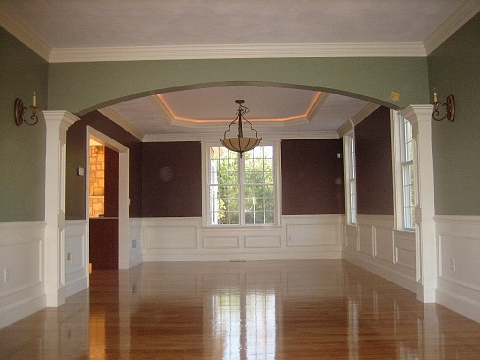 Bay-window room with painted trim and polished hardwood floors