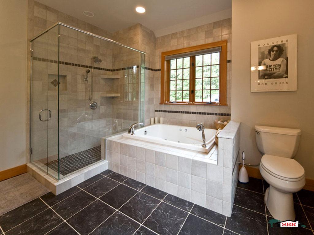 Bathroom with frameless glass shower and a soaking tub