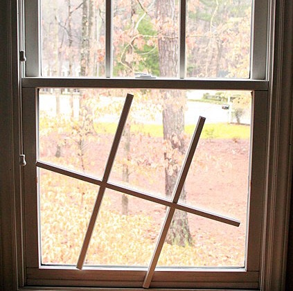 A double-hung window with its muntin bars set aside during a repair