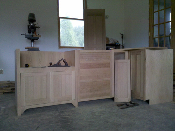 Cabinet stock and a hand plane on a shop bench