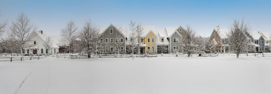 Snow-blanketed New England village under a clear winter sky