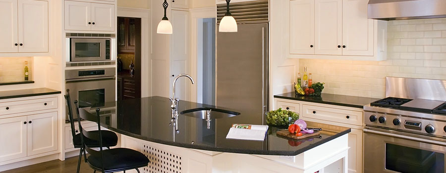 Kitchen wired by Wheaton Electrical Service, with pendant lights over the island and lighting under the cabinets