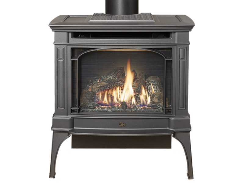 Freestanding gas stove on legs with a lit fire behind the arched screen